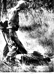 1st Cav trooper stands over PAVN soldier at LZ Xray