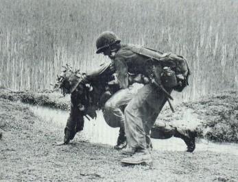 A 1st Cav trooper helping wounded brother